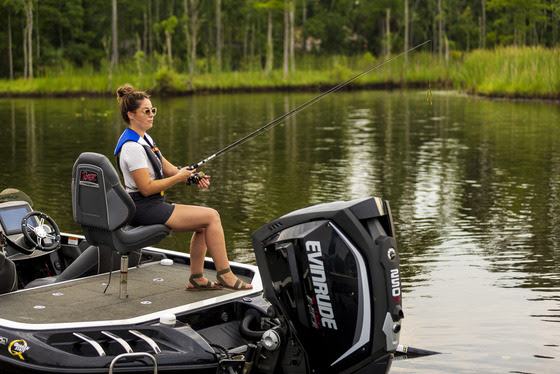 woman wearing sunglasses and life jacket fishing on a boat