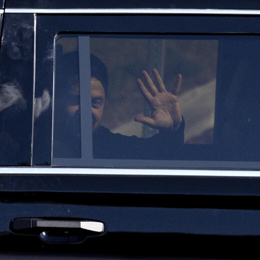 Ukrainian President Volodymyr Zelenskyy waves from the back seat of a U.S. Secret Service vehicle as his motorcade departs the Wilkes-Barre/Scranton International Airport in Pittston Township, Pa., en route to the Scranton Army Ammunition Plant in Scranton, Pa., on Sunday, Sept. 22, 2024. (Christopher Dolan/The Times-Tribune via AP)