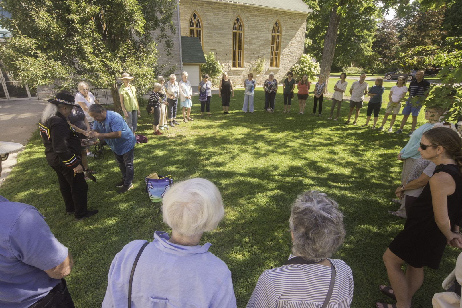 35 people attending a ceremony led by Elder Larry McDermott on the lawn of Almonte United Church, Ontario