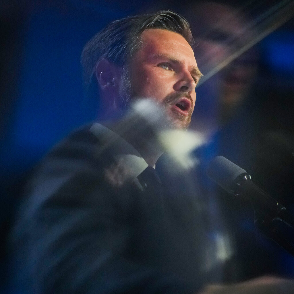 J.D. Vance speaking at a lectern.