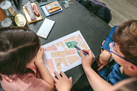 Family walking through an emergency plan at home next to emergency kit supplies.