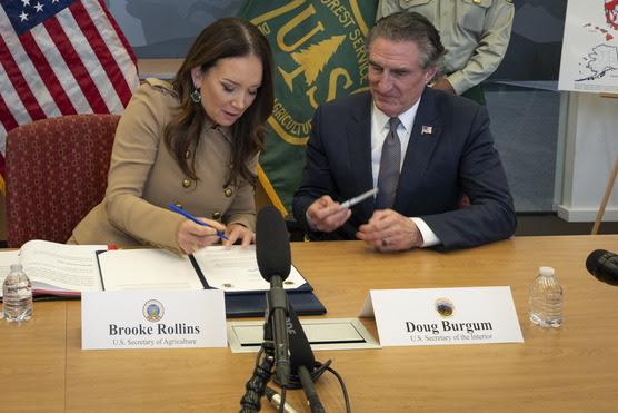 U.S. Secretary of Agriculture Brooke Rollins and U.S. Secretary of the Interior Doug Burgham sign a memorandum of understanding