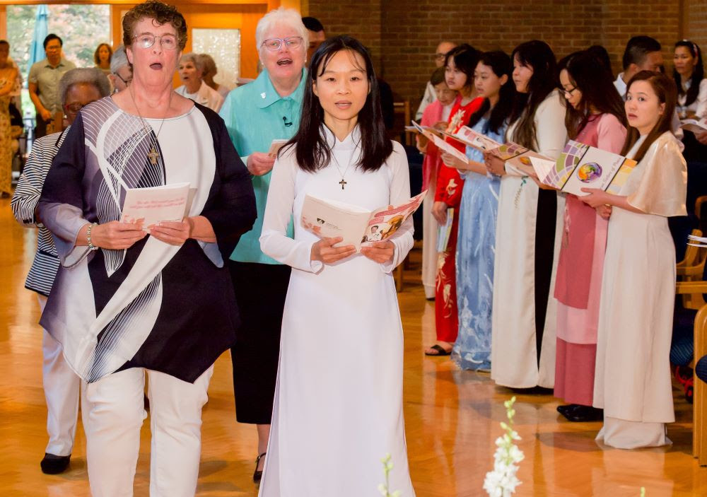 Cathy Buchanan, left, and Tram Bui make their first vows for the Dominican Sisters of Peace in 2023.