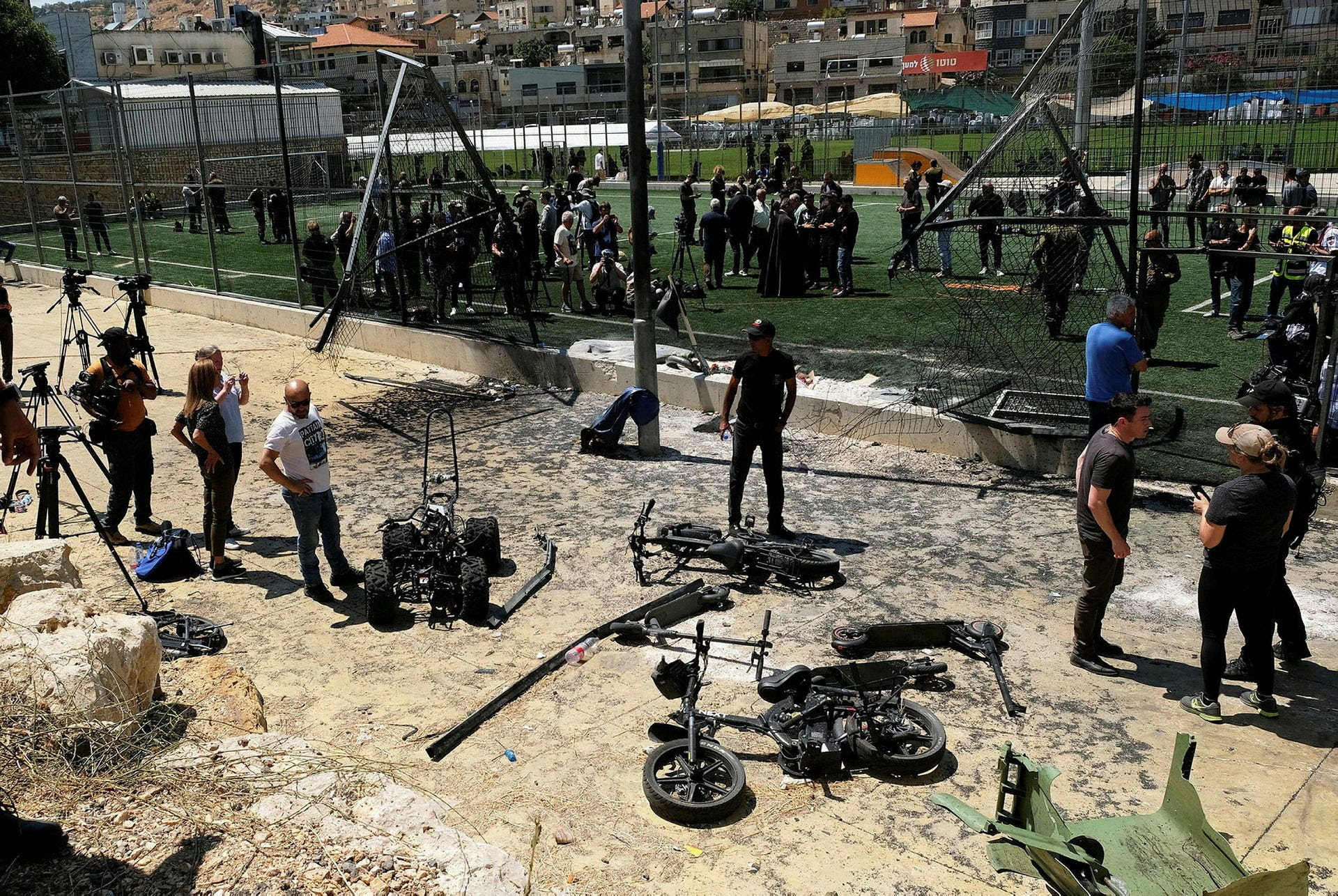 A damaged fence and destroyed bikes at the spot where a rocket from Lebanon killed 12 children in Majdal Shama, Sunday.