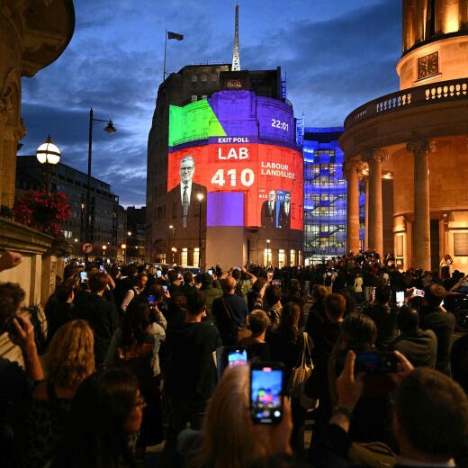 An exit poll predicting that the Labour Party led by Keir Starmer will win 410 seats in Britain's general election is projected onto BBC Broadcasting House in London on July 4, 2024. Labour is set for landslide win in UK election, exit polls showed. (Photo by Oli SCARFF / AFP)