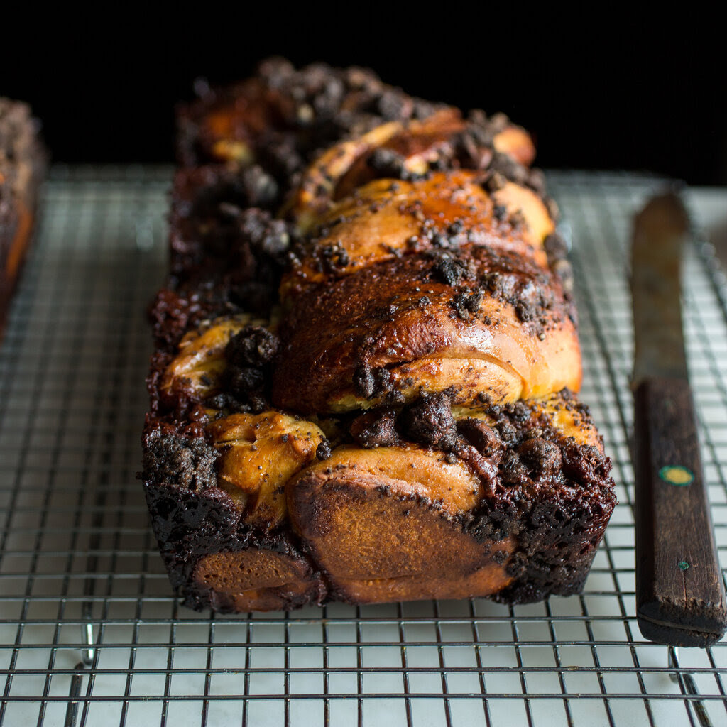 A Chocolate Babka sits on a cooling rack.