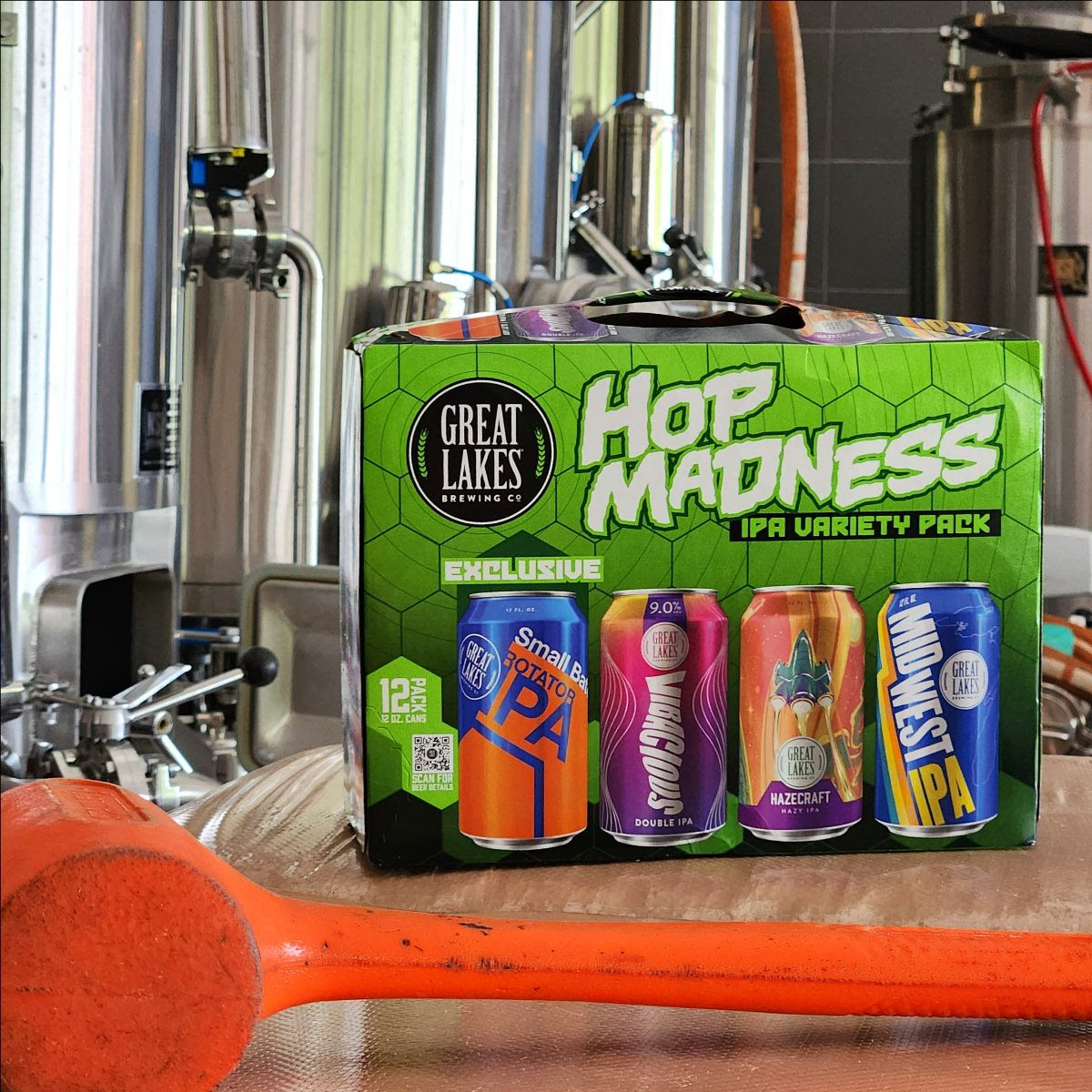 Hop Madness Variety Pack with blue and orange can Small Batch Rotator IPA by the GLBC pilot brewhouse, with an orange mallet in the foreground.