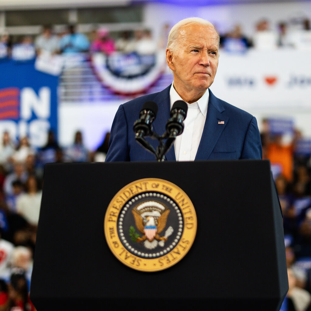 President Biden standing at a lectern during a rally in Detroit.