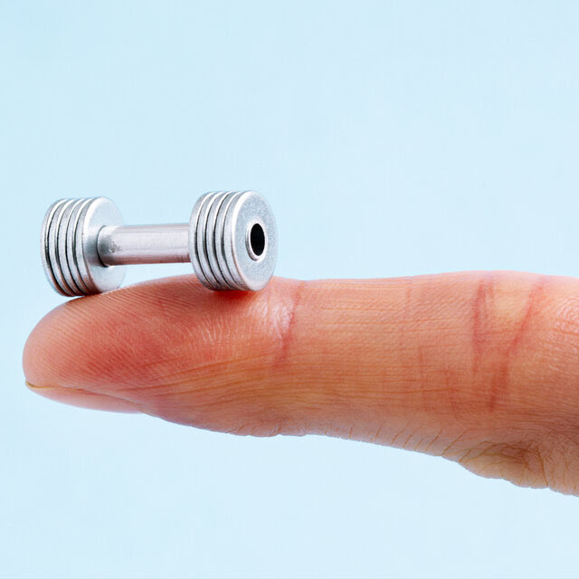 A photo illustration of a tiny barbell on the end of a finger; the background is light blue.