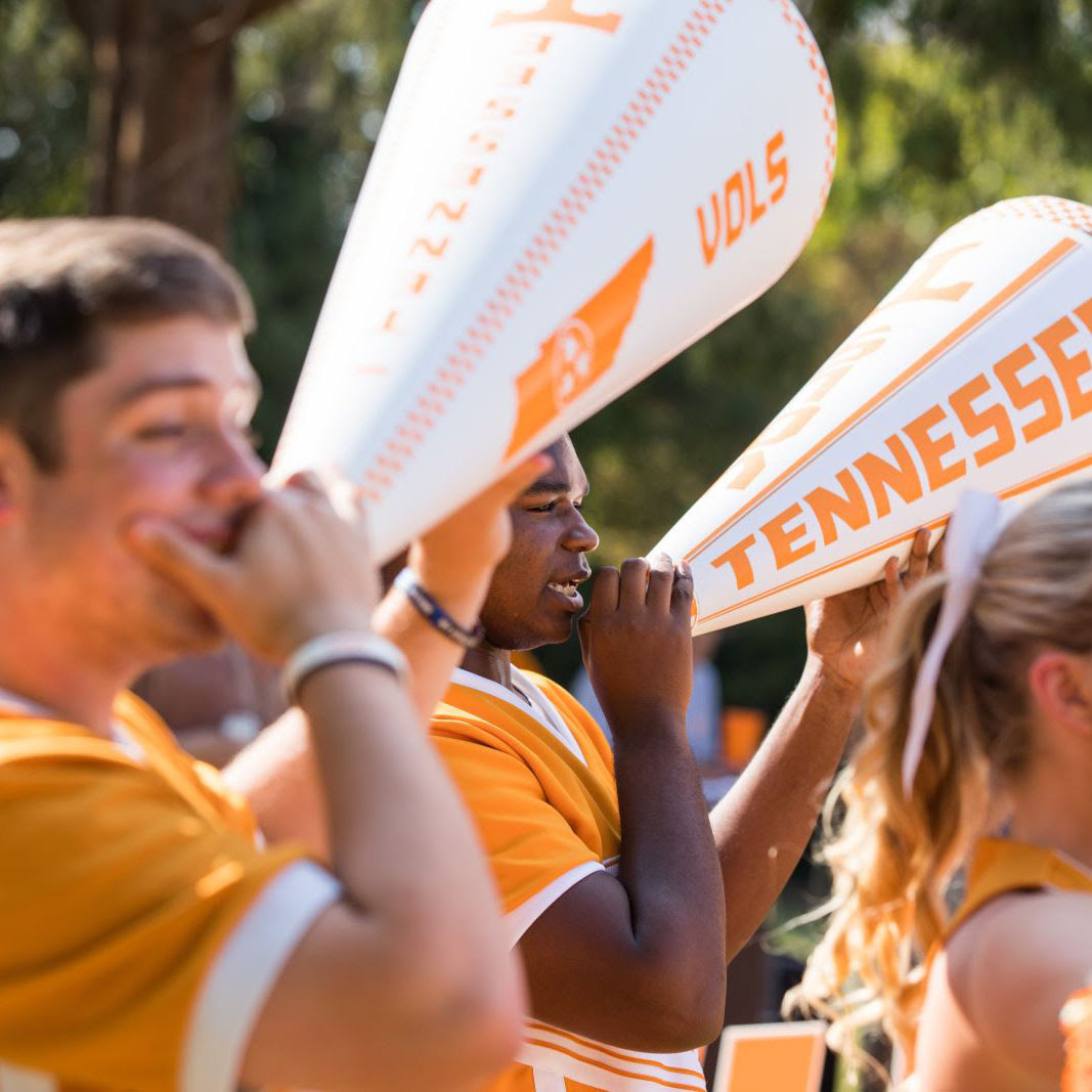 Two cheerleaders using megaphones