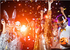 Party-goers at a festive party wearing Halloween costumes.