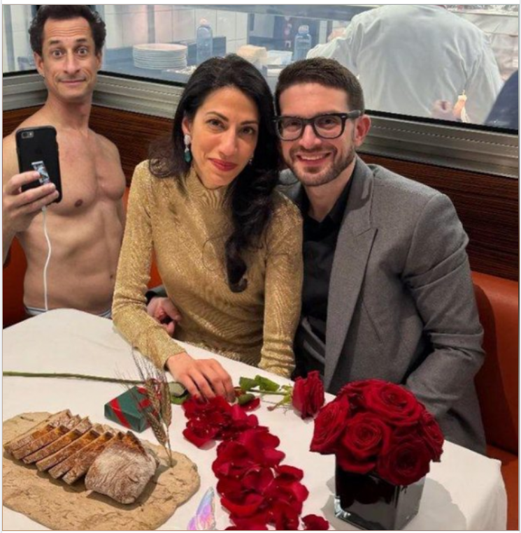 Random picture of naked Anthony Weiner in background where his wife is having dinner.'