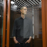 Evan Gershkovich in a glass box in a Russian courtroom.