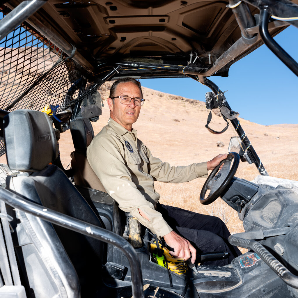 Drew Miller in the driver’s seat of an all-terrain vehicle. 