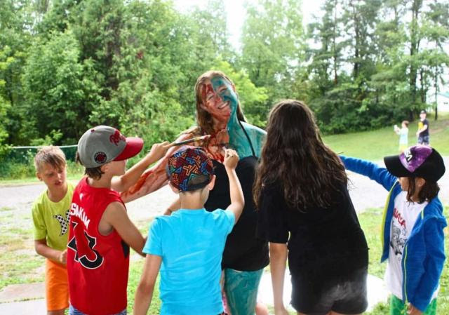 Children Painting a Camp Leader at Cave Springs Camp