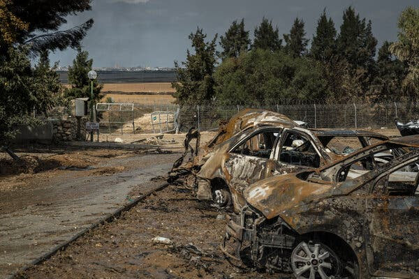 Charred cars and a battered gate.