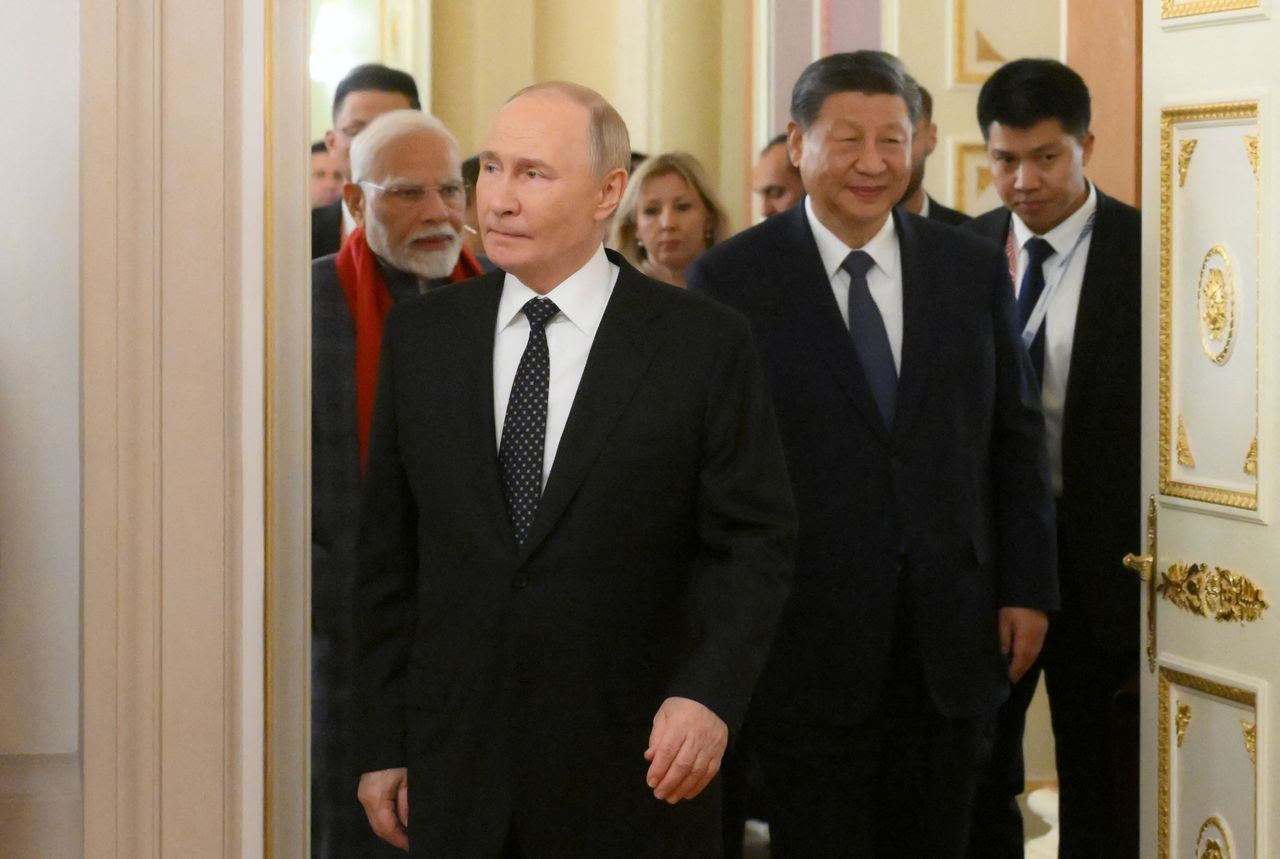 Russian President Vladimir Putin, Chinese leader Xi Jinping and Indian Prime Minister Narendra Modi arrive for an informal dinner during the BRICS summit in Kazan, Russia, on Tuesday. (Aleksey Nikolskyi/BRICS-RUSSIA2024.RU/Reuters)