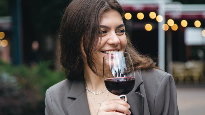 Woman drinking a glass of red wine.