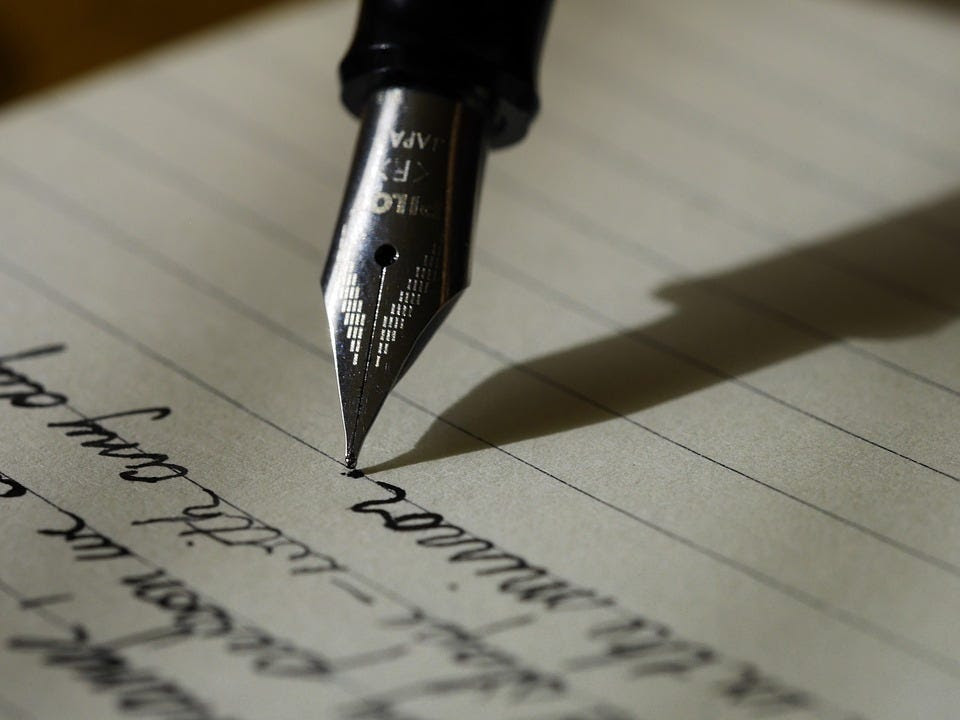 Pen writing on paper.