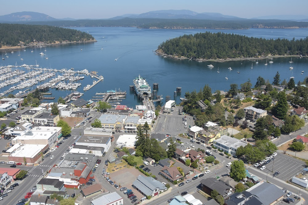 Aerial view of Friday Harbor terminal with a ferry at the dock and other islands in the background