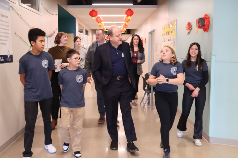 GVA students walking through the school halls with Governor Jared Polis