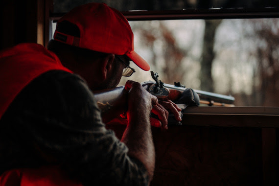 A man aiming a muzzleloader.