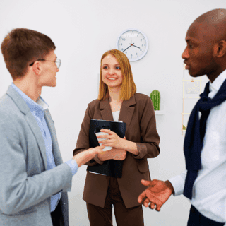Manager speaking to two younger, gen-z employees