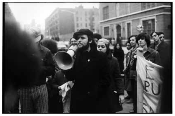 Photo of Richie Perez speaking into a megaphone