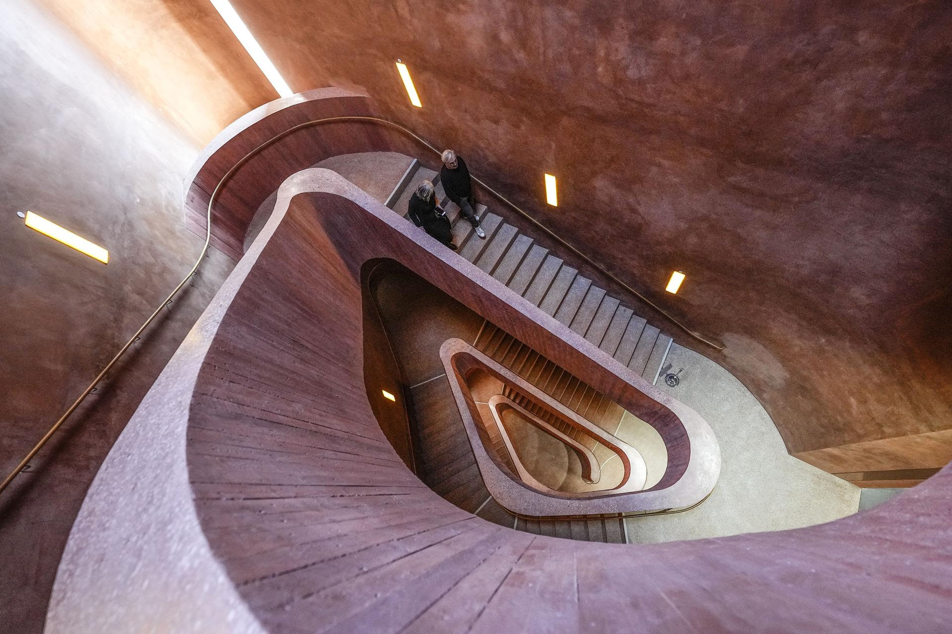 People walk down stairs at the Kueppersmuehle Center for Modern and Contemporary Art in Duisburg, Germany.