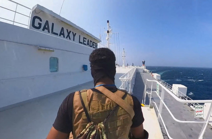 A Houthi fighter stands on the Galaxy Leader cargo ship in the Red Sea in this photo released November 20, 2023. (credit: Houthi Military Media/Handout via REUTERS)