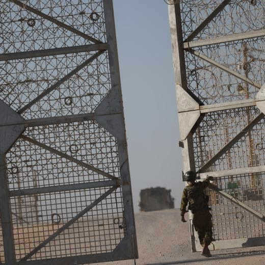 epa11714438 An Israeli soldier stands guard beside the border gate of the Erez crossing, on the border with northern Gaza Strip, in southern Israel, following the crossing of World Food programme aid trucks, 11 November 2024. According to the Israeli Army (Tsahal) and Coordination of Government Activities in the Territories (COGAT), 40 World Food Programme (WFP) aid trucks crossed into the northern Gaza Strip from Israel. According to the United Nations over 1.8 million people in Gaza face extreme hunger. EPA/VASSIL DONEV