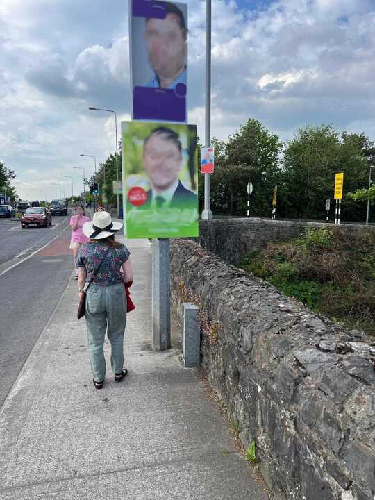  Caption: Low-hanging election posters on pathways. 