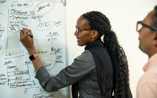 Sharon Umunyana, Technical Project Manager, Rwanda Information Society Authority (RISA), attends a brainstorming meeting regarding the implementation of Mojaloop software with RSwitch staff at the WiredIn offices in Kigali, Rwanda, on July 24, 2024.