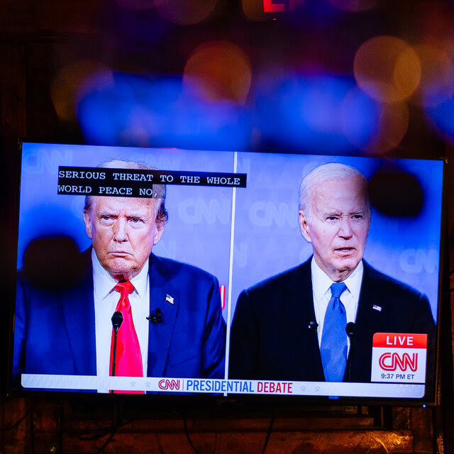 A television screen shows Donald Trump and Joe Biden during a recent debate on CNN.