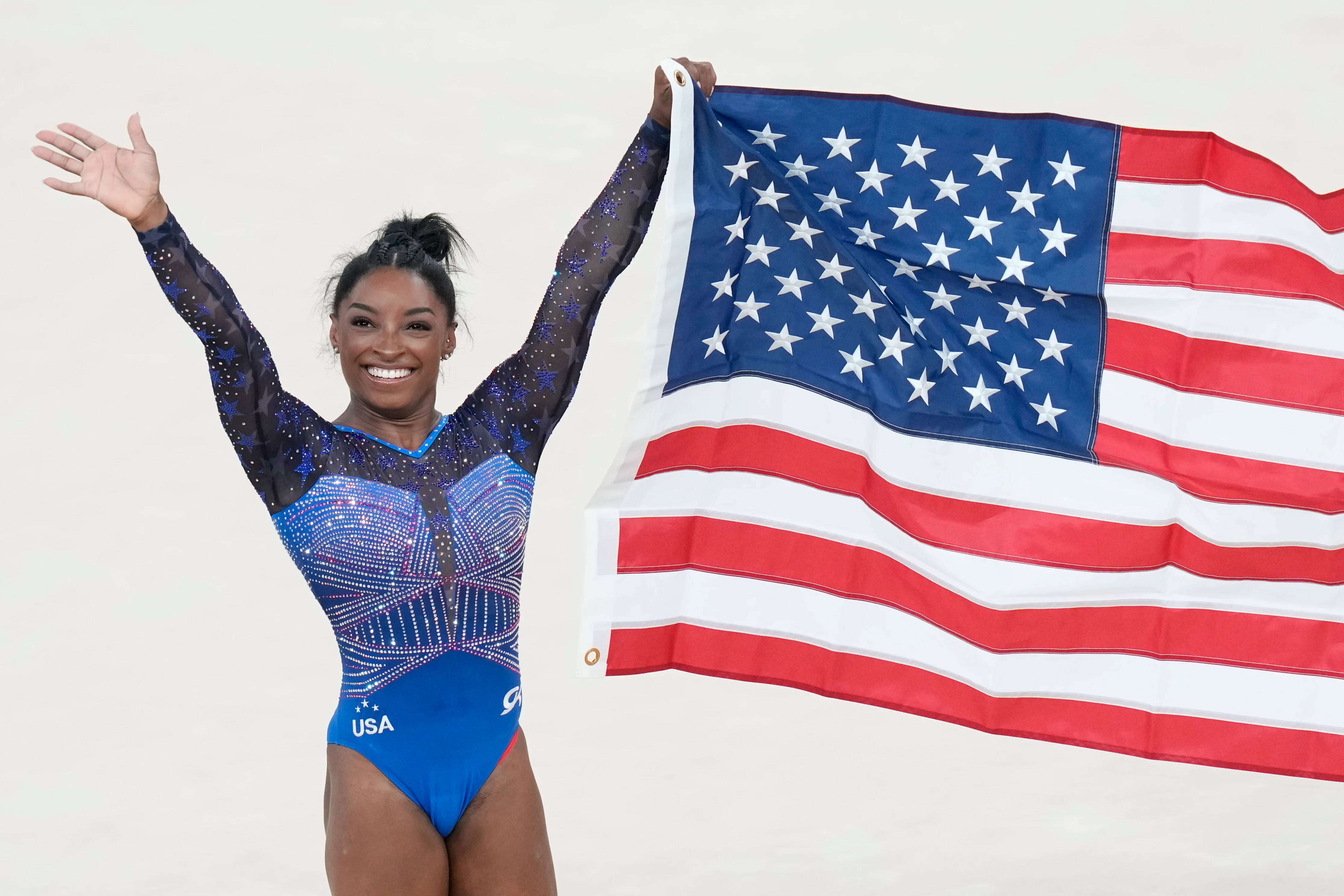 Simone Biles celebrates after winning the gold medal during the women's artistic gymnastics all-around finals on Thursday.