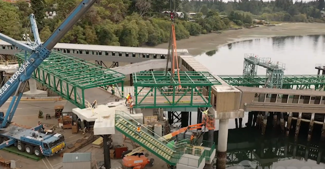 The green bridge spans are lifted by crane at the Bainbridge terminal.