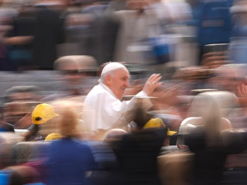 A photo of Pope Francis waving as he arrives for his weekly general audience in St. Peter’s Square, in Vatican City.