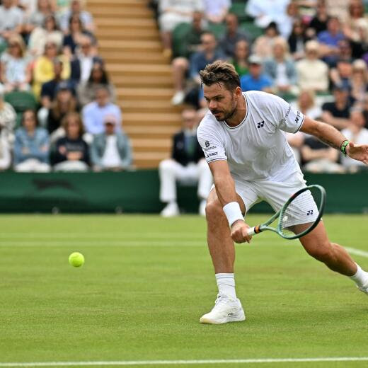 Switzerland's Stan Wawrinka returns against Britain's Charles Broom during their men's singles tennis match on the first day of the 2024 Wimbledon Championships at The All England Lawn Tennis and Croquet Club in Wimbledon, southwest London, on July 1, 2024. (Photo by ANDREJ ISAKOVIC / AFP) / RESTRICTED TO EDITORIAL USE