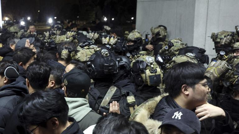 South Korean martial law soldiers try to enter the National Assembly compound in Seoul, South Korea, Wednesday, Dec. 4, 2024. (Cho Sung-bong/Newsis via AP)