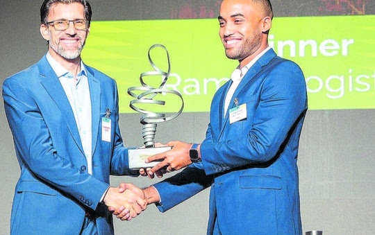 Director of the St Augustine Centre for Innovation and Entrepreneurship, University of the West Indies, Dr Graham King, left, presents the Innovation and Technology Challenge award to Gerard Rique, manager of innovations and solutions at Ramps Logistics. PHOTO COURTESY T&T ENERGY CHAMBER