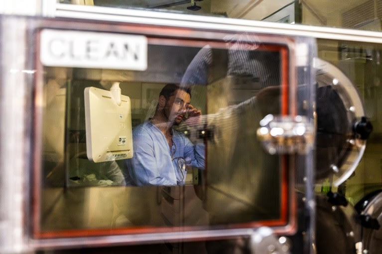 View through a window of a participant in a medical study into the effects of diet waking up from sleeping overnight in a small metabolic chamber