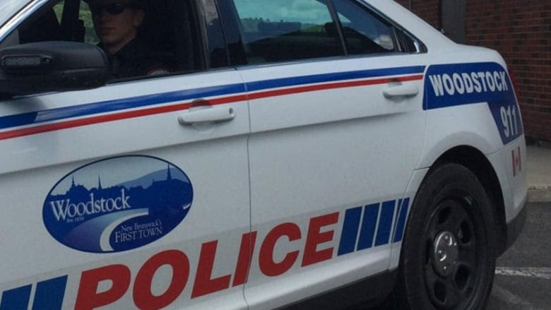 A white-and-blue police car that says POLICE on it in red letters.