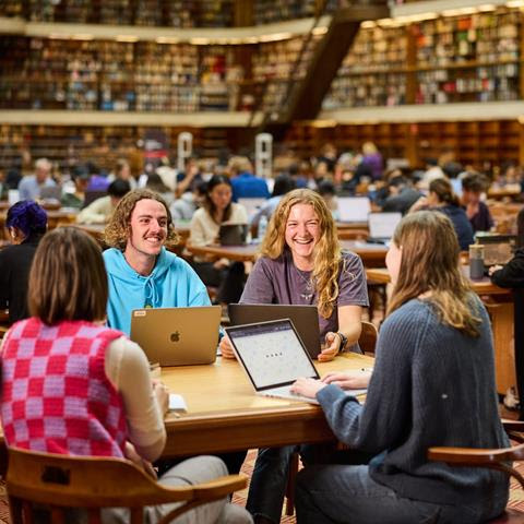 Group of young people at a table in a library