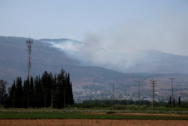 Smoke rises, amid ongoing cross-border hostilities between Hezbollah and Israeli forces, in Kiryat Shmona, northern Israel, June 14, 2024. (photo credit: AMMAR AWAD/REUTERS)