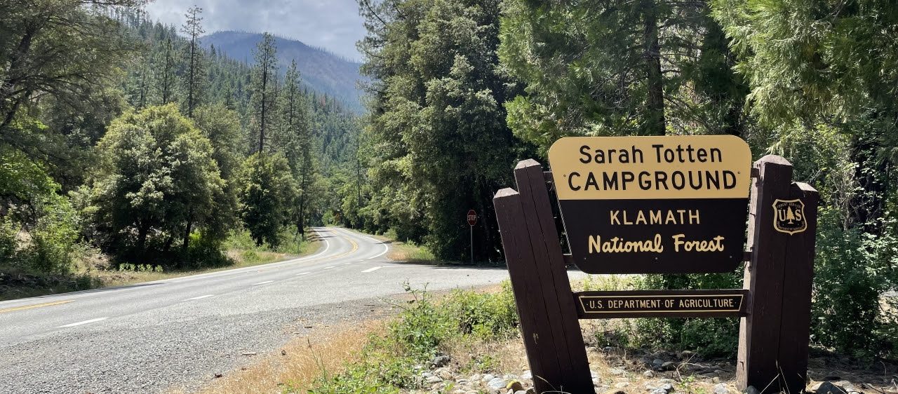 Roadside sign that says Sarah Totten Campground, Klamath National Forest, and U.S. Department of Agriculture