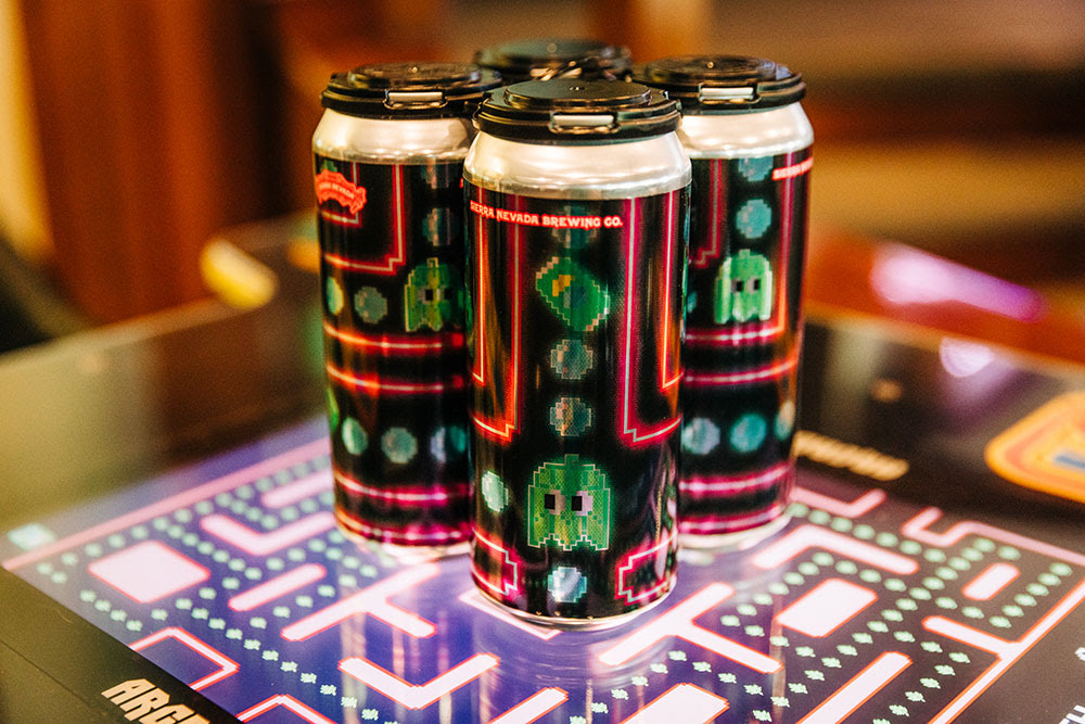 A four-pack of West Ghost IPA on top of an arcade game