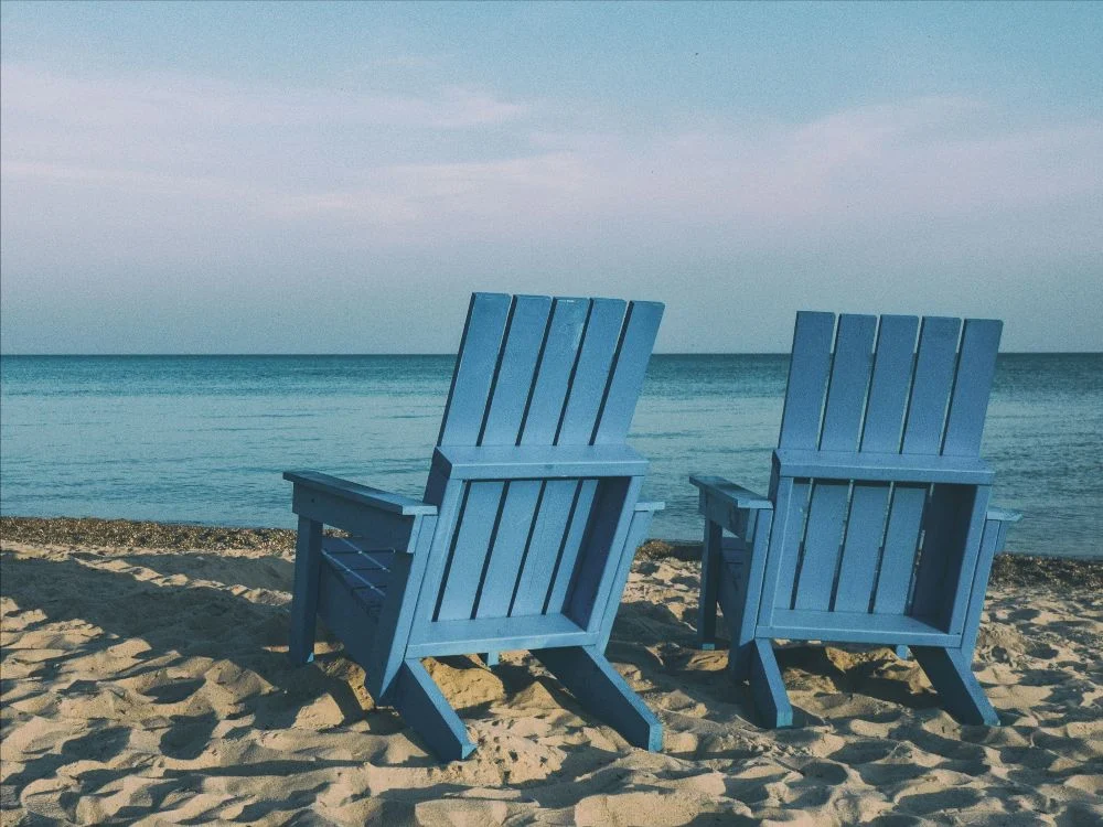 Beach chairs, photo by Aaron Burden on Unsplash