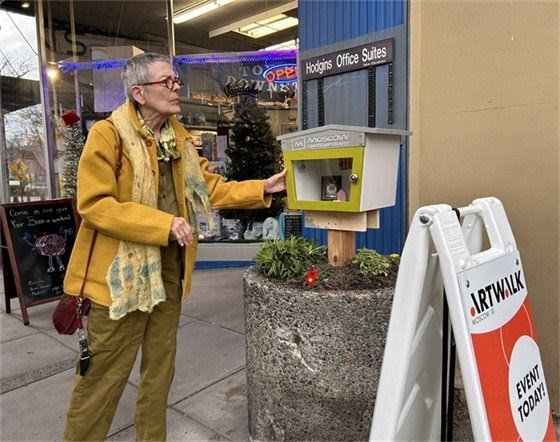 Artwalk participant observing art.