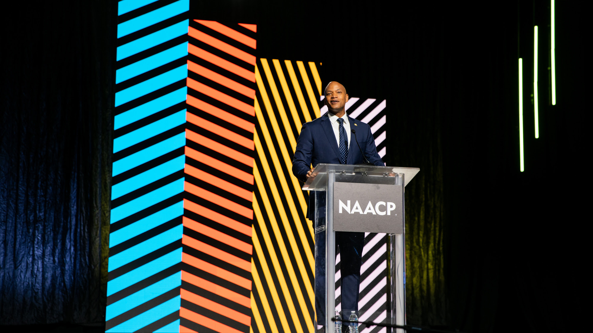 Governor Wes Moore standing on stage at 115th NAACP Convention