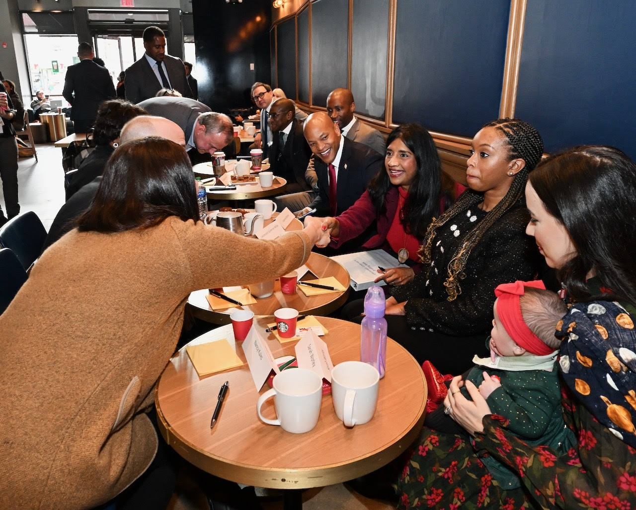 Governor Moore and Lt. Governor Miller chat with military families in an Annapolis Starbucks.